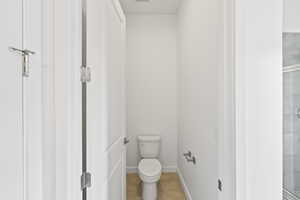 Full bathroom featuring light tile patterned flooring and a stall shower