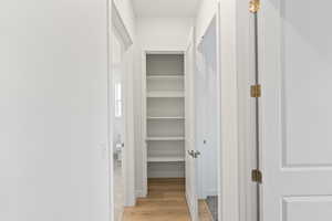 Hallway with light wood-style floors