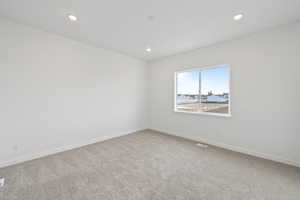 Empty room featuring carpet floors and recessed lighting