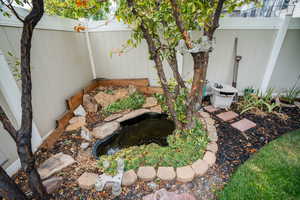 Fenced backyard with a small water feature