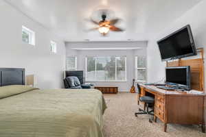 Primary Bedroom with carpet floors, a ceiling fan, and a desk