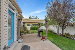 Fenced backyard featuring a grill, a patio, and a Covered patio