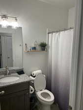 Bathroom with vanity and curtained shower