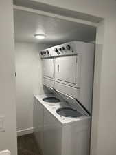 Laundry area featuring a textured ceiling and estacked washer and dryer