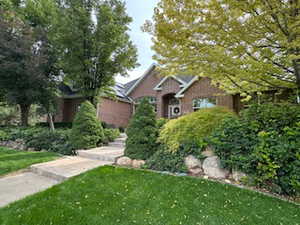 View of front facade with a front yard and brick siding