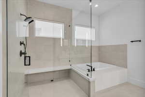 Bathroom featuring a shower stall, a bath, tile patterned floors, and recessed lighting
