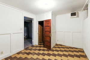Utility room, with wood closet and laminate flooring.