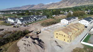 Aerial view of property's location with nearby suburban area and a mountainous background