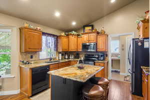 Large Kitchen with stainless steel appliances and beautiful backsplash.