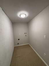 Laundry room featuring a textured ceiling, hookup for a washing machine, and hookup for an electric dryer