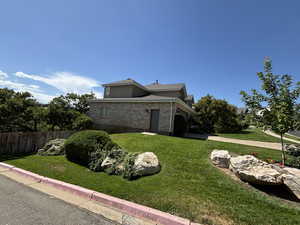 View of property exterior featuring brick siding and driveway