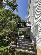 View of green lawn featuring a wooden deck