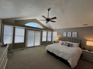 Bedroom with carpet flooring, vaulted ceiling, a textured ceiling, and ceiling fan