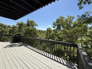 Wooden deck featuring a grill