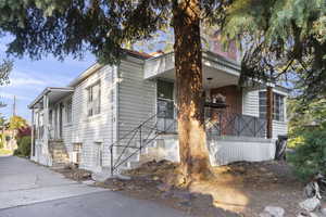 View of property exterior featuring stairs and a chimney