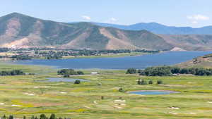 View of mountain background with a large body of water and a golf club