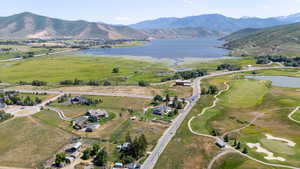 Aerial view of property's location featuring a water and mountain view