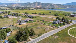 Aerial view of property's location featuring a water and mountain view
