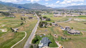Aerial overview of property's location with a mountain backdrop and nearby suburban area
