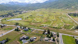 Aerial view of property's location with a water and mountain view and a golf club