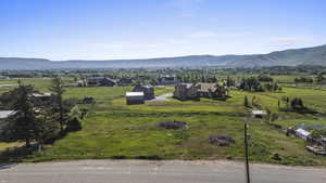View of mountain backdrop with rural landscape and a pastoral area