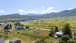 Aerial view of a water and mountain view and a golf course