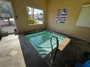 View of pool with a hot tub