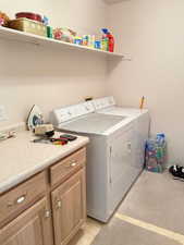 Laundry room featuring washer and dryer and cabinet space
