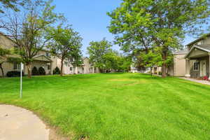 View of green lawn featuring a residential view