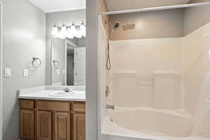 Bathroom featuring shower / bath combination and vanity