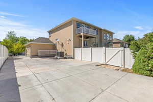 Rear view of property with a gate and stucco siding