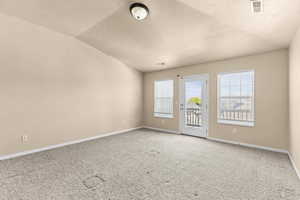 Spare room with carpet and baseboards