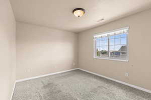 Carpeted empty room with baseboards
