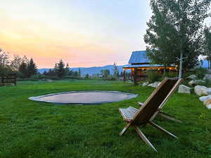 View of grassy yard with a patio