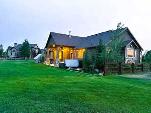 Rear view of property with a patio and stone siding