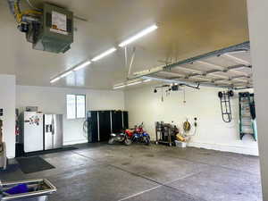 Garage with stainless steel fridge and freestanding refrigerator