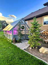 View of grassy yard featuring an exterior structure and an outdoor structure