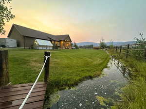 Yard at dusk featuring a mountain view and a patio
