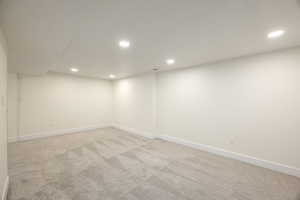 Unfurnished room with light carpet and recessed lighting