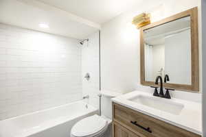 Full bath with  shower combination, vanity, and recessed lighting and laundry hookups
