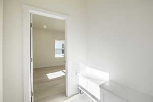 Bathroom featuring light wood-style floors, vanity, and recessed lighting