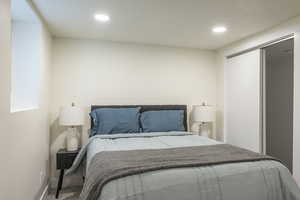 Carpeted bedroom featuring recessed lighting and a closet