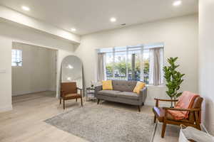 Living room with recessed lighting and light wood finished floors