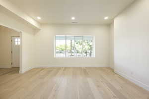 Empty room featuring recessed lighting and light wood-type flooring