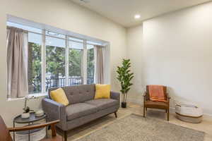 Sitting room with wood finished floors and recessed lighting