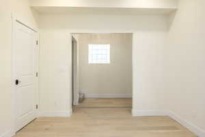 Hallway with baseboards and light wood-type flooring