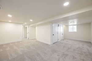 Basement with light colored carpet and recessed lighting