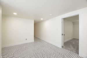 Unfurnished room with recessed lighting and a textured ceiling