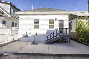 Rear view of property with a patio area and a shingled roof