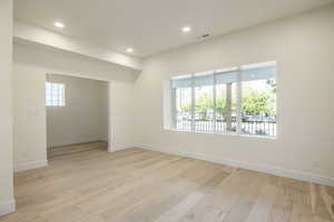 Spare room with light wood finished floors and recessed lighting